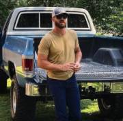 Bearded Stud Leaning On His Truck