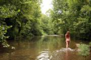 Being Natural In Nature; Nudist Walking In A Stream